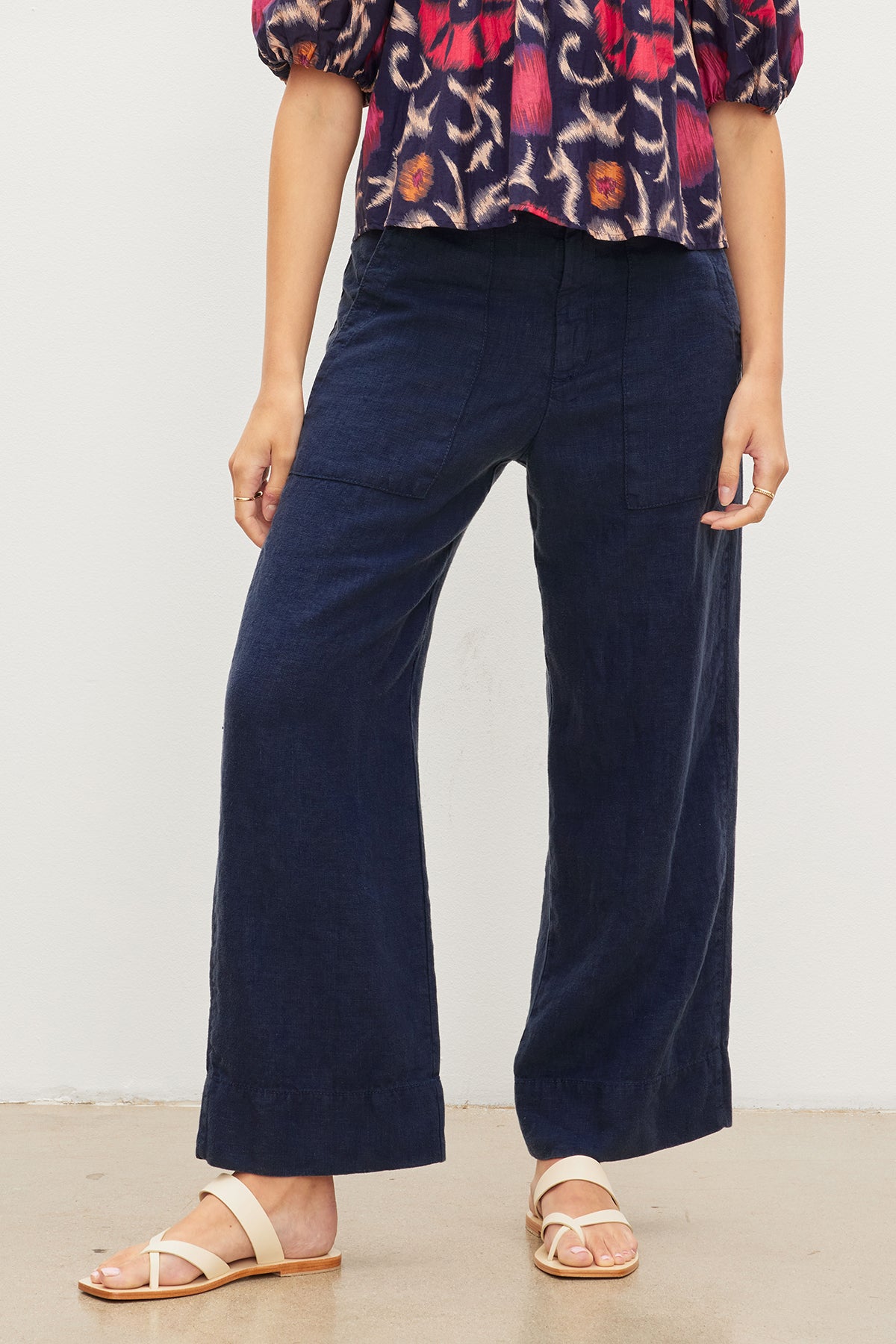   A stylish woman wearing a cool floral top and Velvet by Graham & Spencer DRU HEAVY LINEN PANT wide leg pants. 