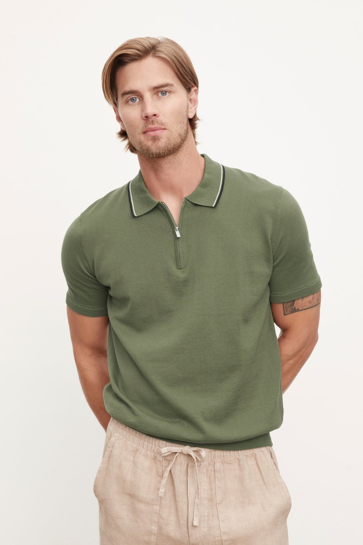   A man in an OTTO ZIP POLO by Velvet by Graham & Spencer. 