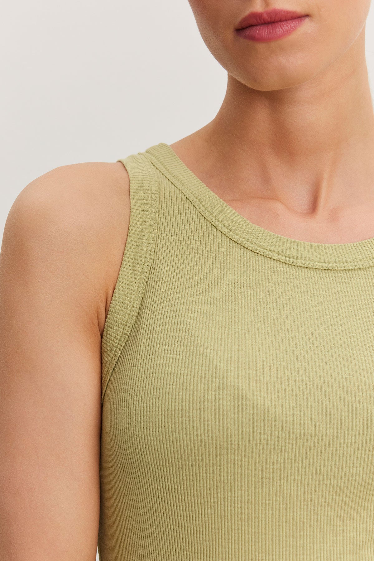   Close-up of a woman wearing a Velvet by Graham & Spencer NOLA tank top, showcasing the fabric texture and neckline. 