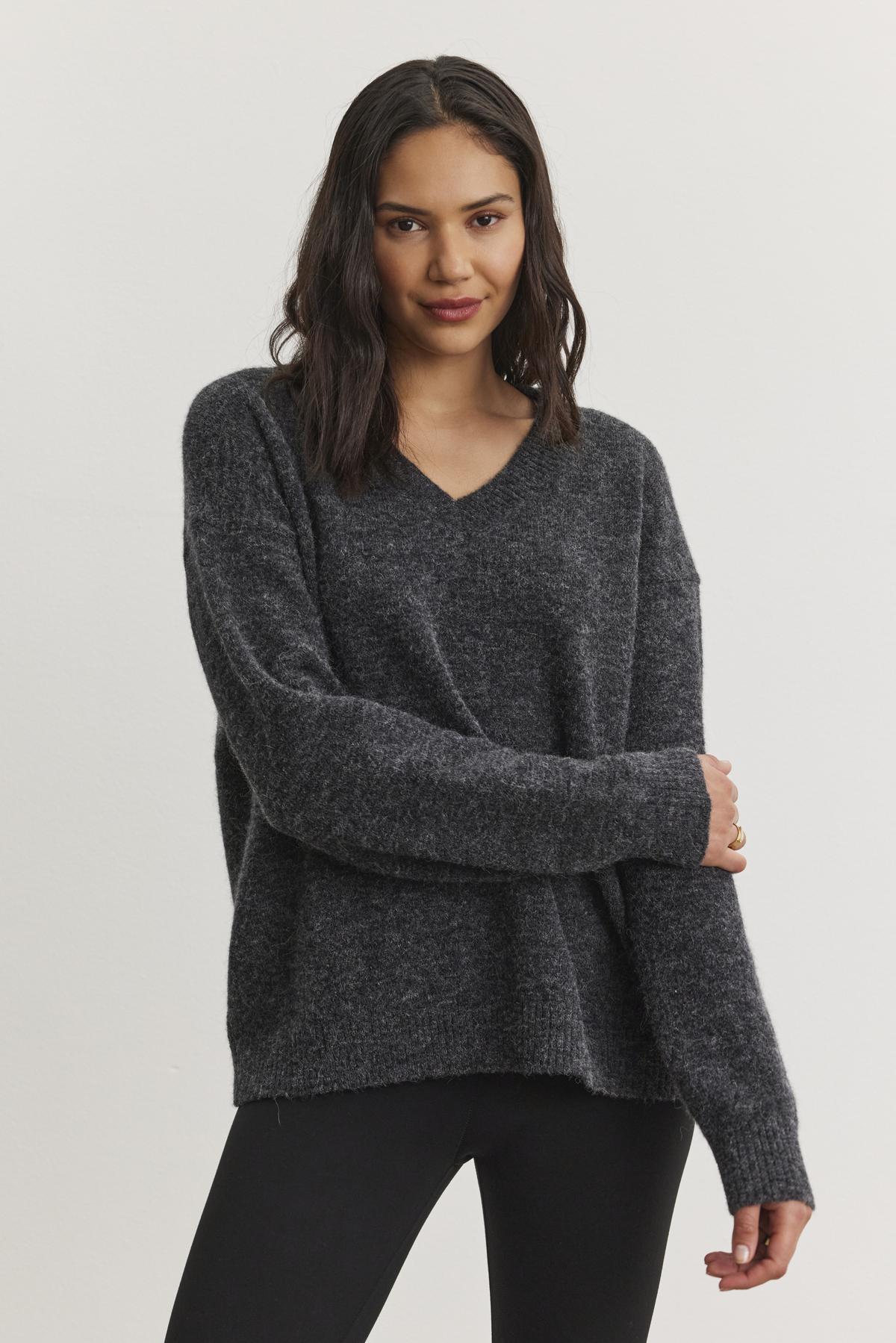 A person wearing the KELSA ALPACA SWEATER by Velvet by Graham & Spencer, paired with black pants, against a plain white background.-38246531793089