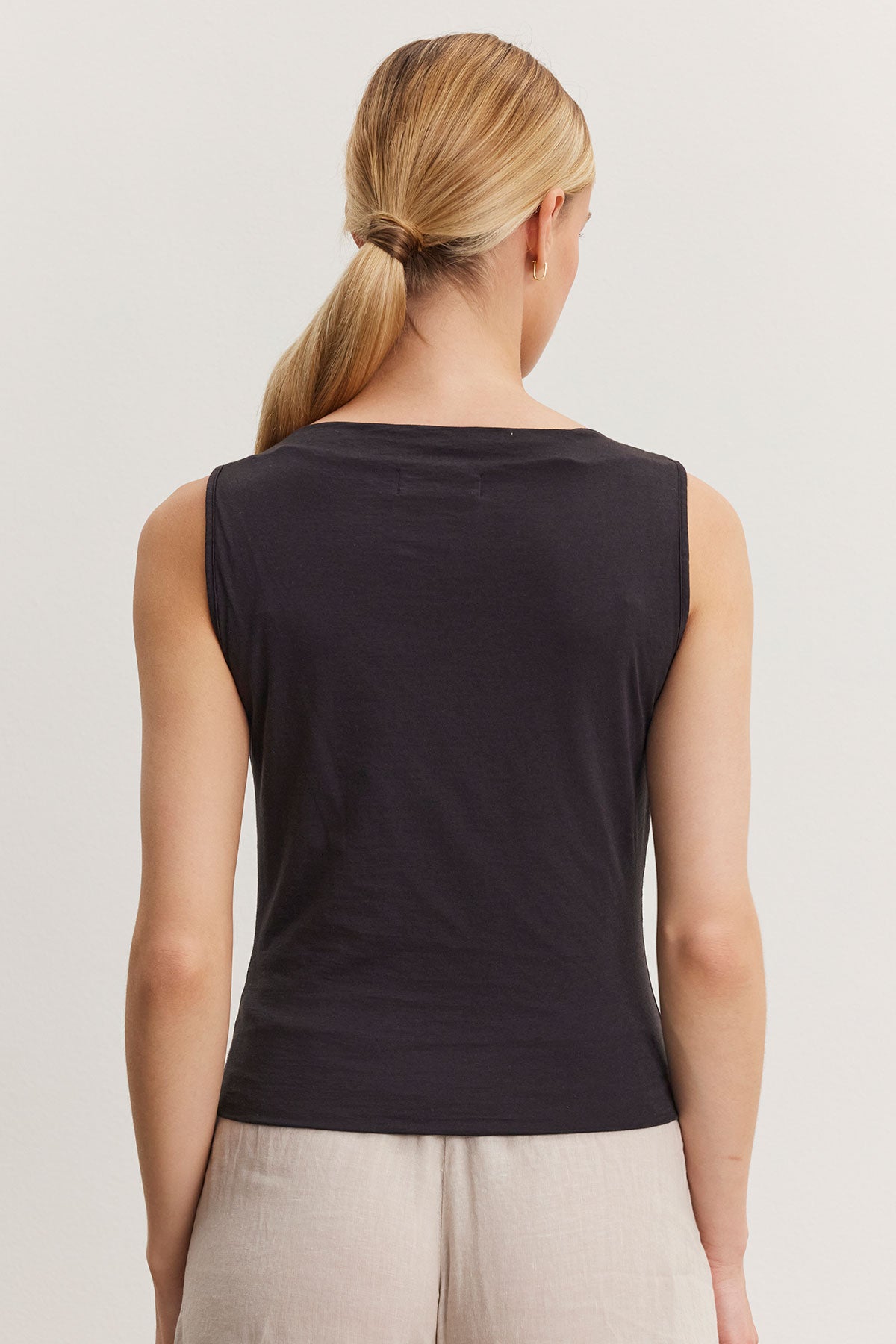 Woman wearing an Emilia tank top by Velvet by Graham & Spencer, viewed from the back, with a ponytail hairstyle.-36998745325761