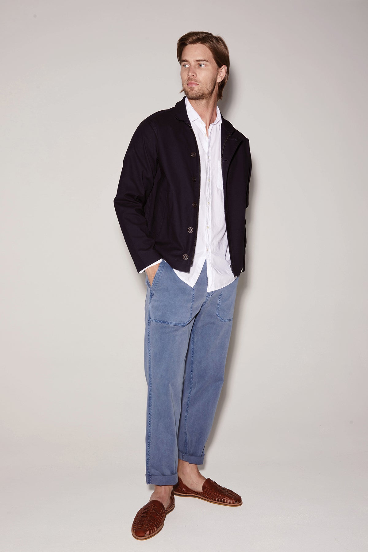   A man wearing a white shirt and Velvet by Graham & Spencer's TOBY SANDED TWILL PANT. 