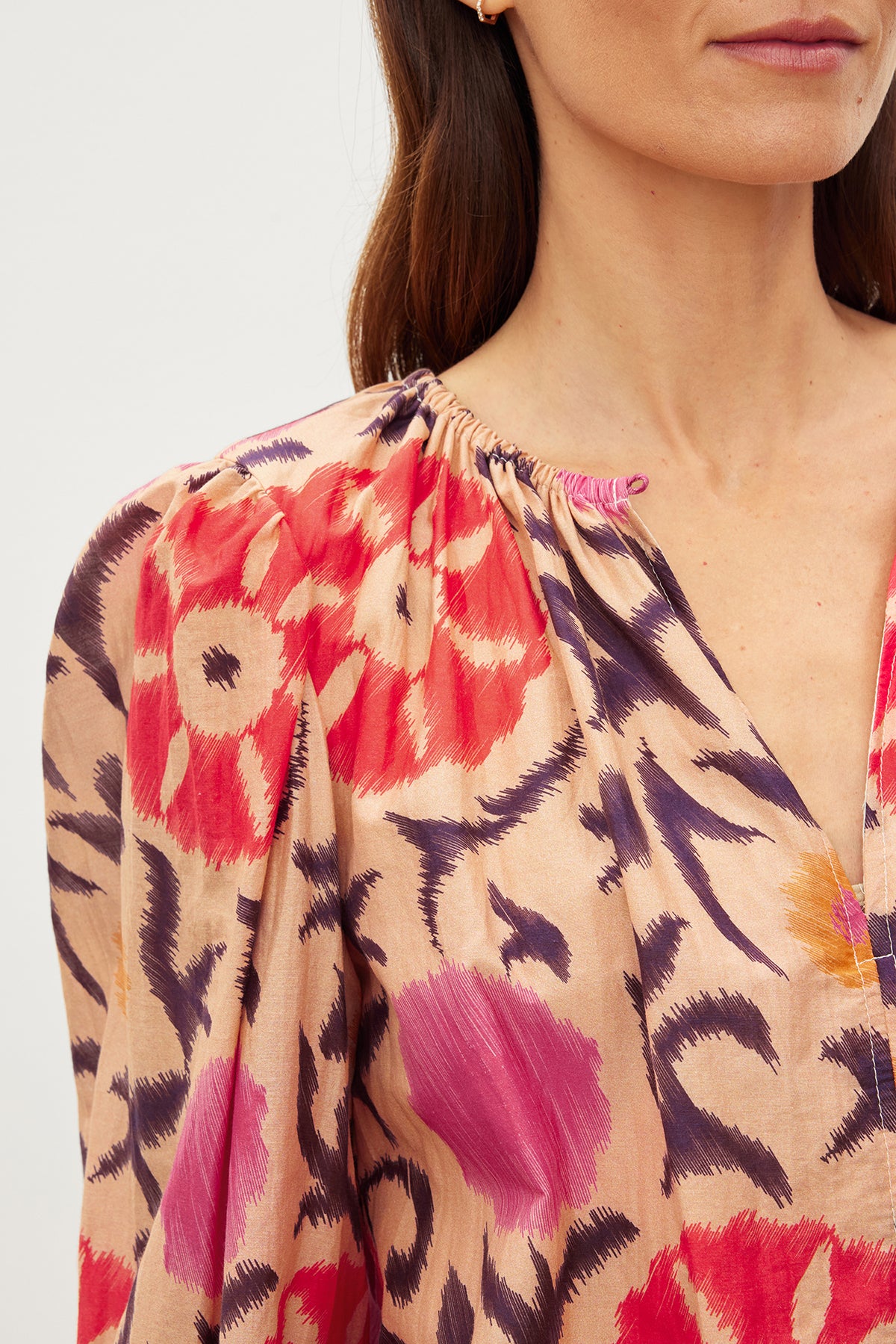   A woman wearing a Velvet by Graham & Spencer FRASER PRINTED SILK COTTON VOILE TOP with a floral print. 