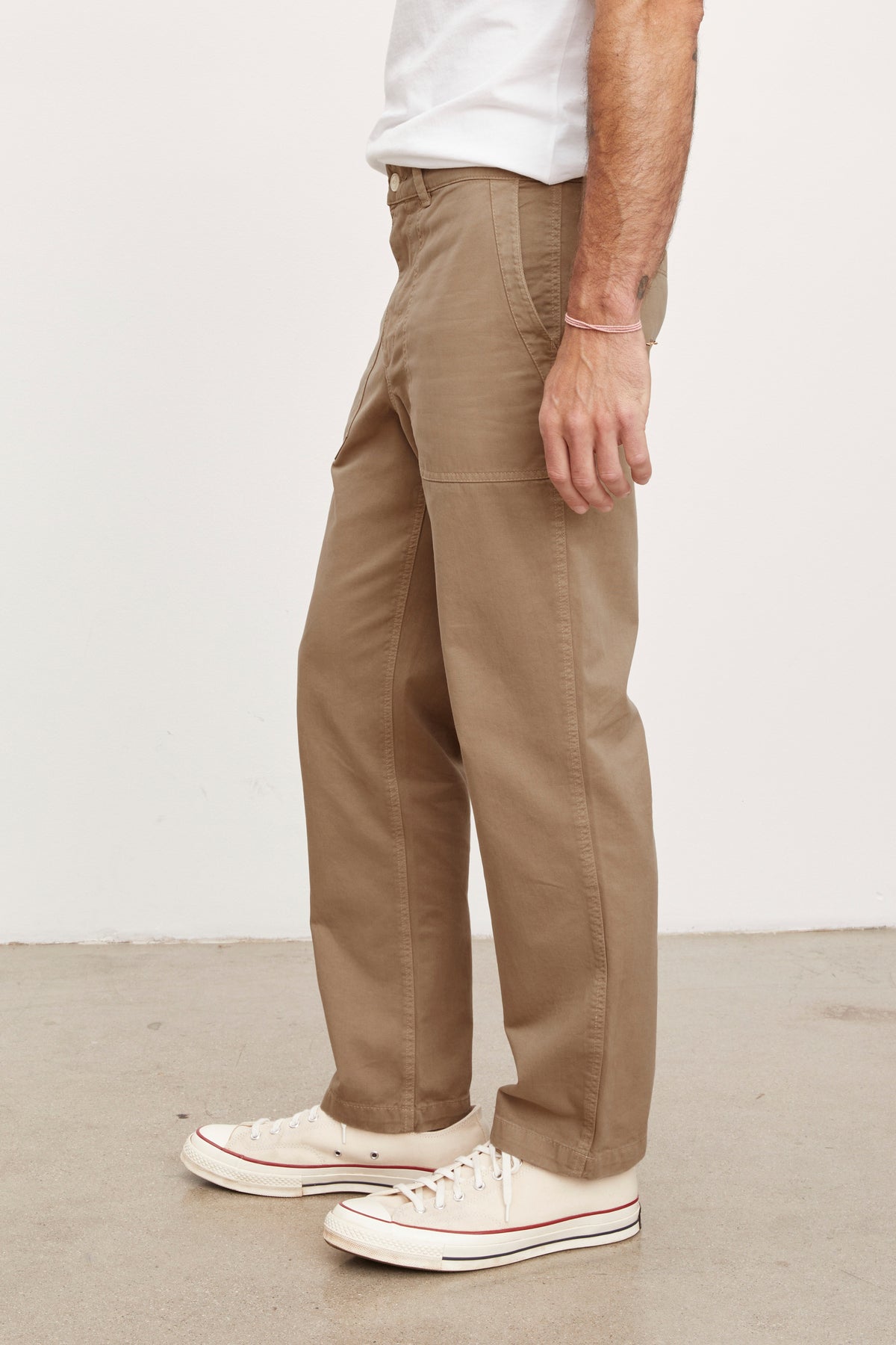   A man wearing Velvet by Graham & Spencer's TOBY SANDED TWILL PANT and white sneakers. 