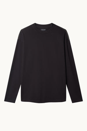 The SLATER TEE by Velvet by Graham & Spencer is a black long-sleeve shirt made from structured pima cotton jersey, featuring a round neckline on a plain white background. Its relaxed fit ensures comfort, making it a versatile wardrobe essential.