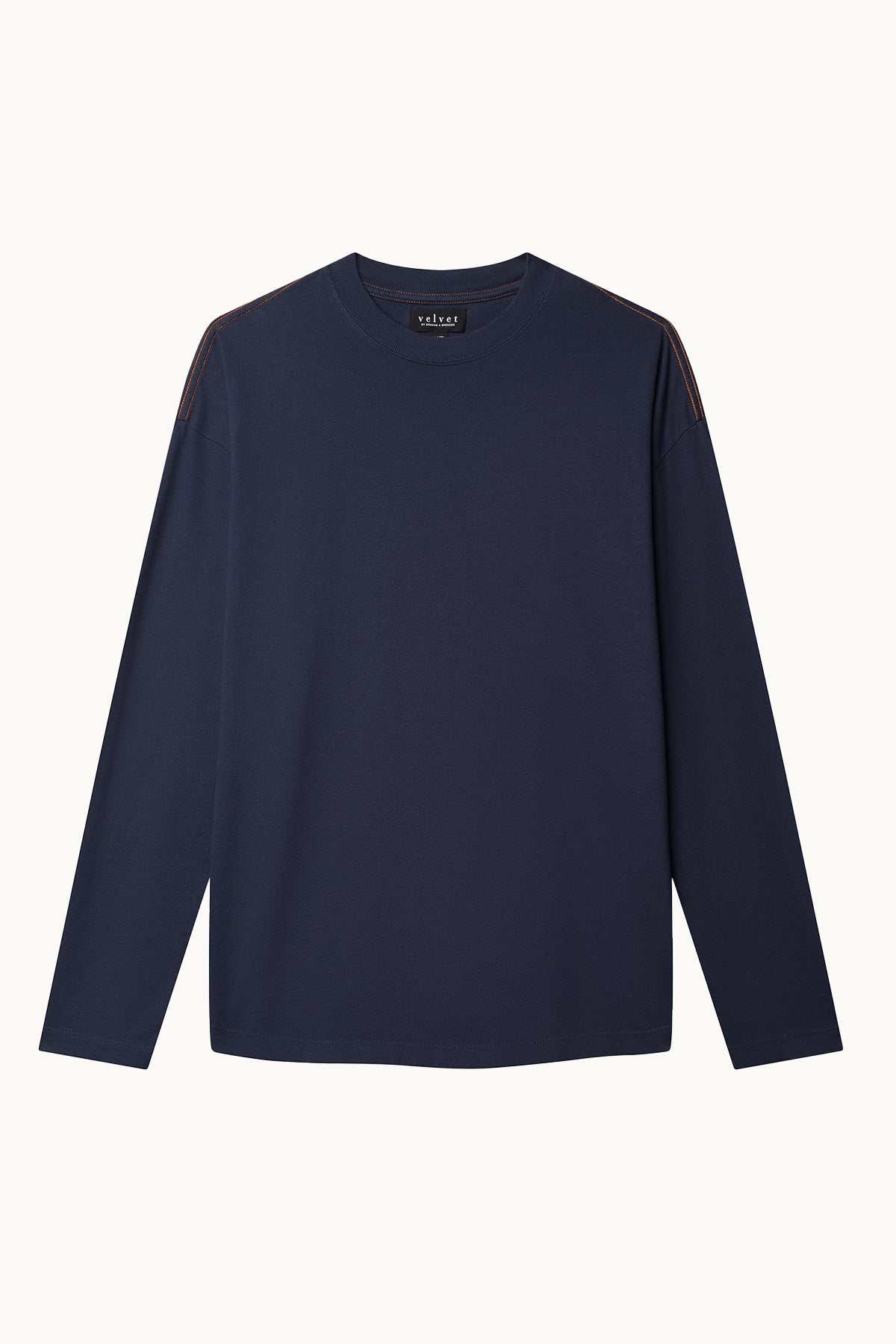 The SLATER TEE by Velvet by Graham & Spencer is a relaxed-fit, long-sleeve shirt in navy blue, made from structured pima cotton jersey. It features brown stitching detail on the shoulders and is photographed laying flat against a white background.-38325889827009