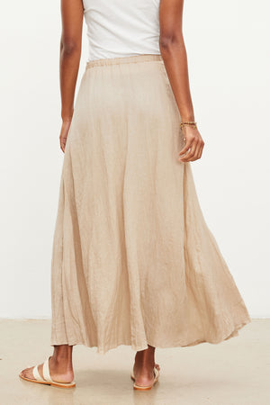 The back view of a woman wearing a Velvet by Graham & Spencer BAILEY LINEN MAXI SKIRT.