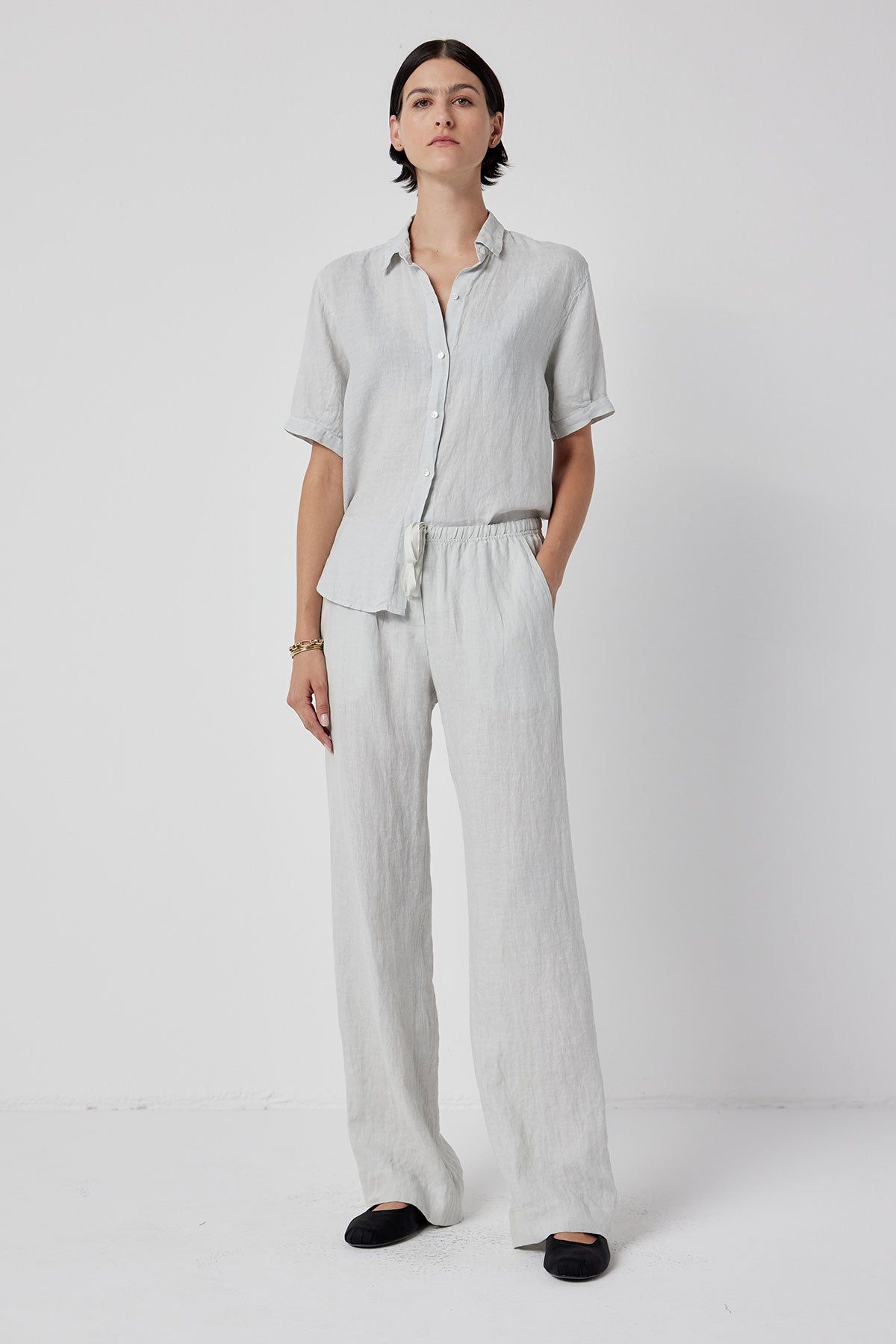   The model is wearing a white linen pant and a MULHOLLAND SHIRT by Velvet by Jenny Graham. 