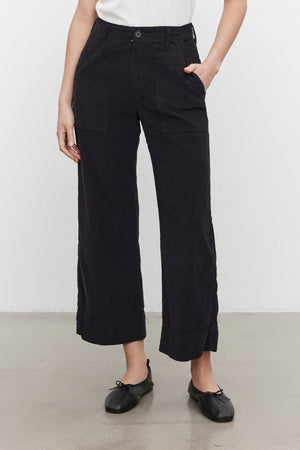 Person wearing VERA CORDUROY PANT by Velvet by Graham & Spencer with black ballet flats, standing against a plain white background.