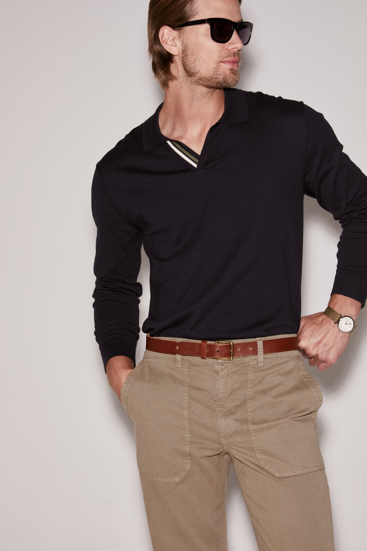   A man wearing a Velvet by Graham & Spencer RICO POLO shirt and khaki pants. 