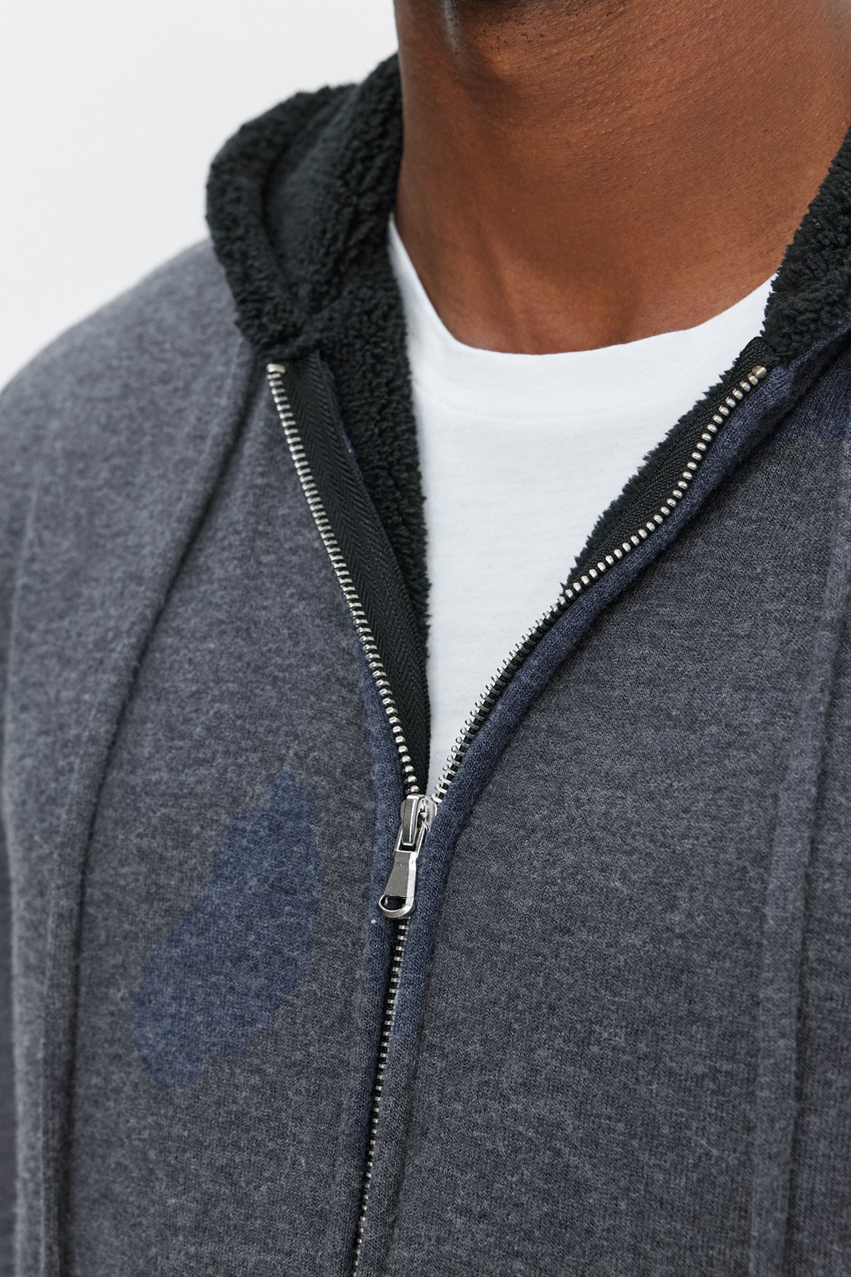 Close-up of a person wearing the SALVADORE HOODIE, an ultra-soft cozy jersey grey full-zip hoodie with a black-lined hood over a white shirt from Velvet by Graham & Spencer.-37893927108801