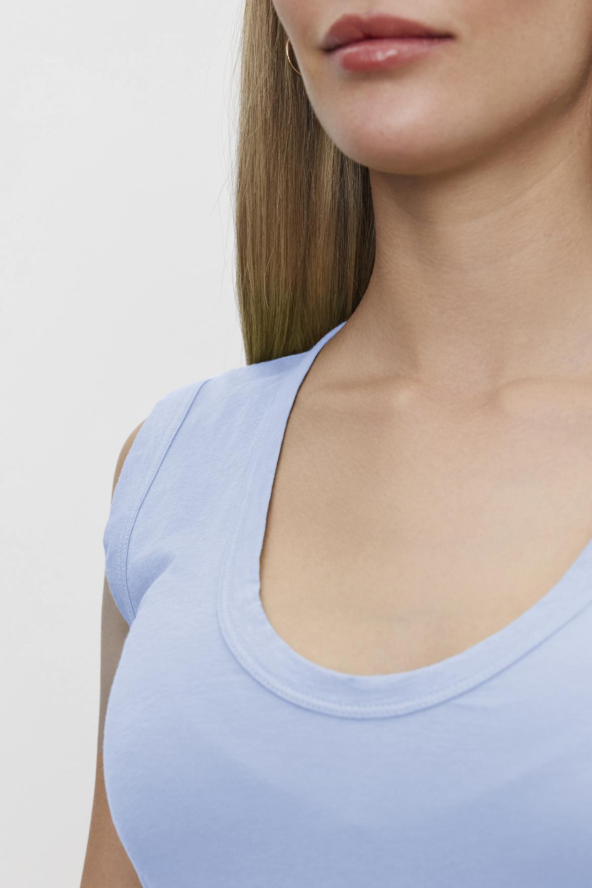 A close-up of a person wearing a Velvet by Graham & Spencer ESTINA TANK TOP, showing their neck and upper chest.-36752924213441