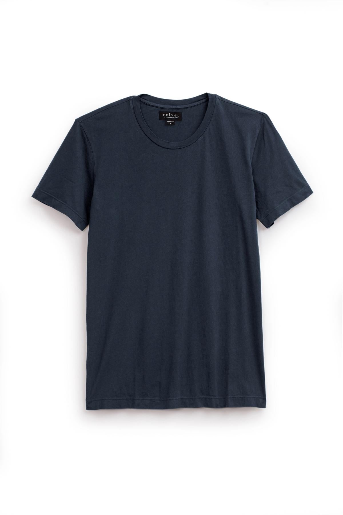   A plain, short-sleeved, dark blue HOWARD TEE with a crew neck is displayed against a white background, showcasing its lightweight cotton knit and perfect fit by Velvet by Graham & Spencer. 