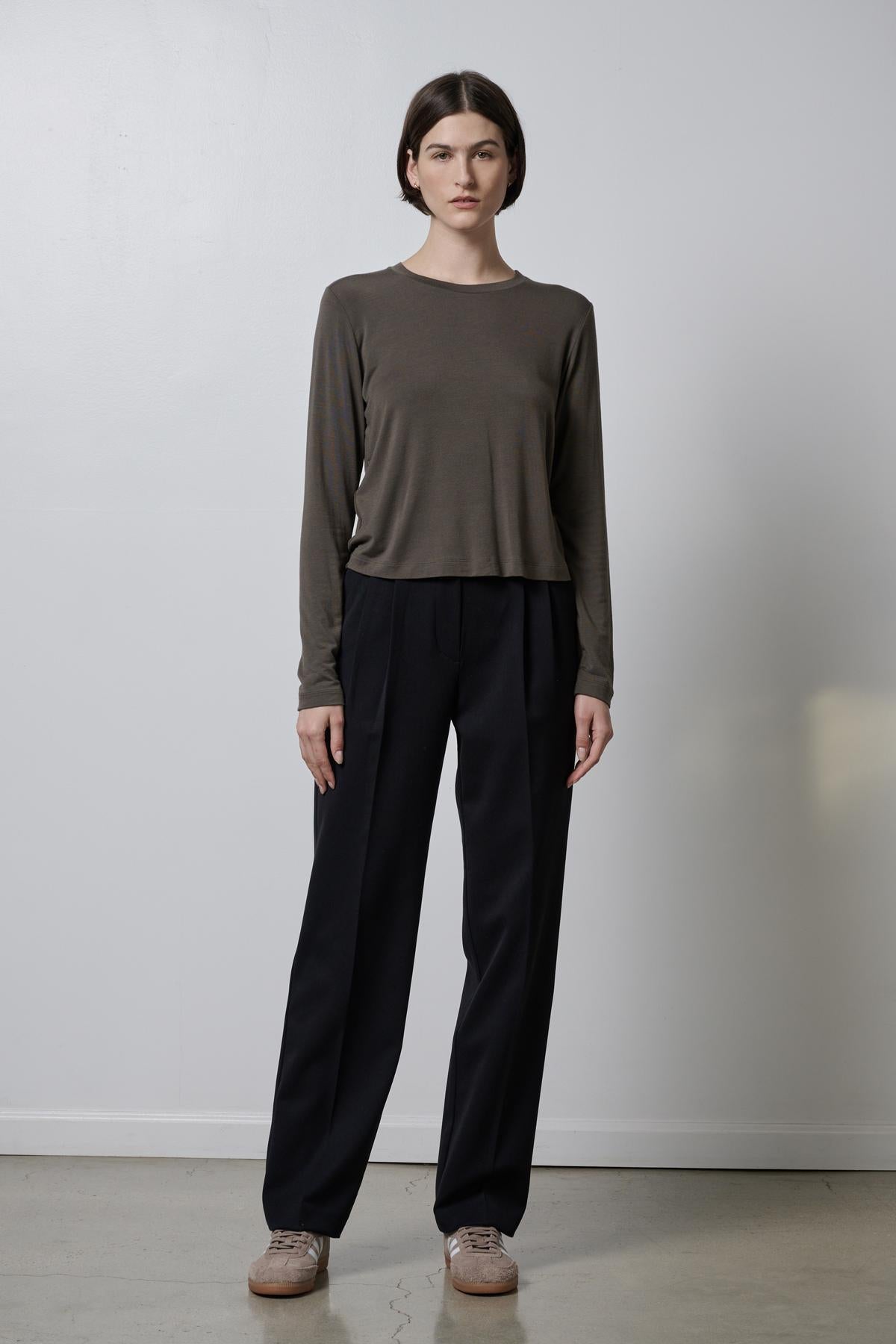   The model is wearing a Velvet by Jenny Graham PACIFICA TEE and soft hand black trousers. 