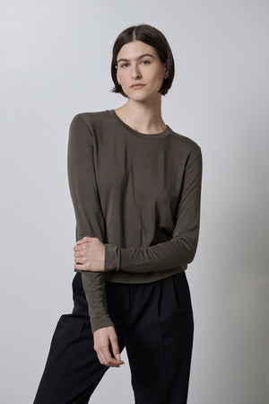 The model is wearing a Velvet by Jenny Graham PACIFICA TEE and soft hand black trousers.