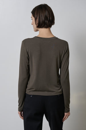 The back view of a woman wearing a Velvet by Jenny Graham PACIFICA TEE in olive.