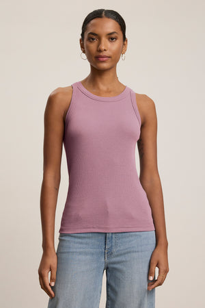 Against a plain background, a person wears the CRUZ TANK TOP by Velvet by Jenny Graham, effortlessly styled with blue jeans to showcase the essence of a capsule wardrobe.