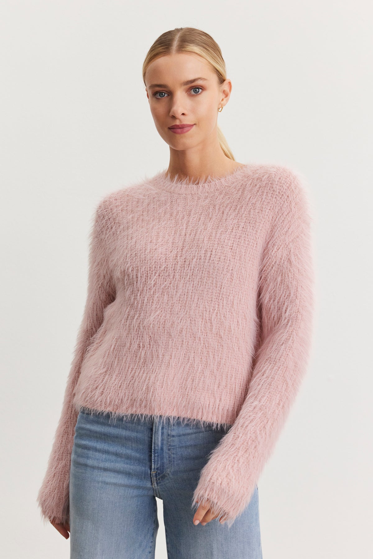 A person wearing the MAYLIE FEATHER YARN SWEATER by Velvet by Graham & Spencer, paired with blue jeans, stands against a plain background.-38483622920385