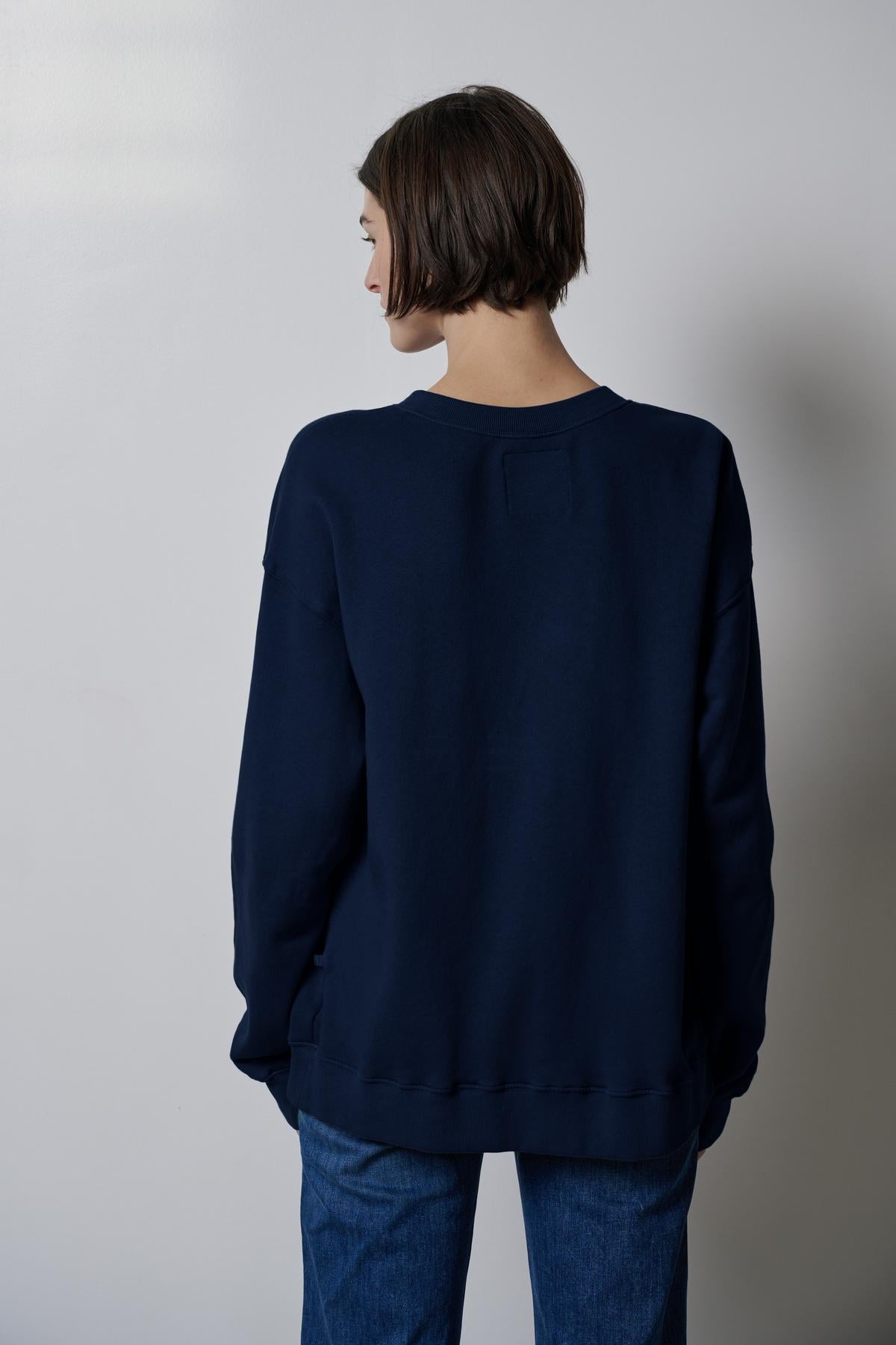   The slouchy back view of a woman wearing a Velvet by Jenny Graham ABBOT SWEATSHIRT made from organic cotton. 