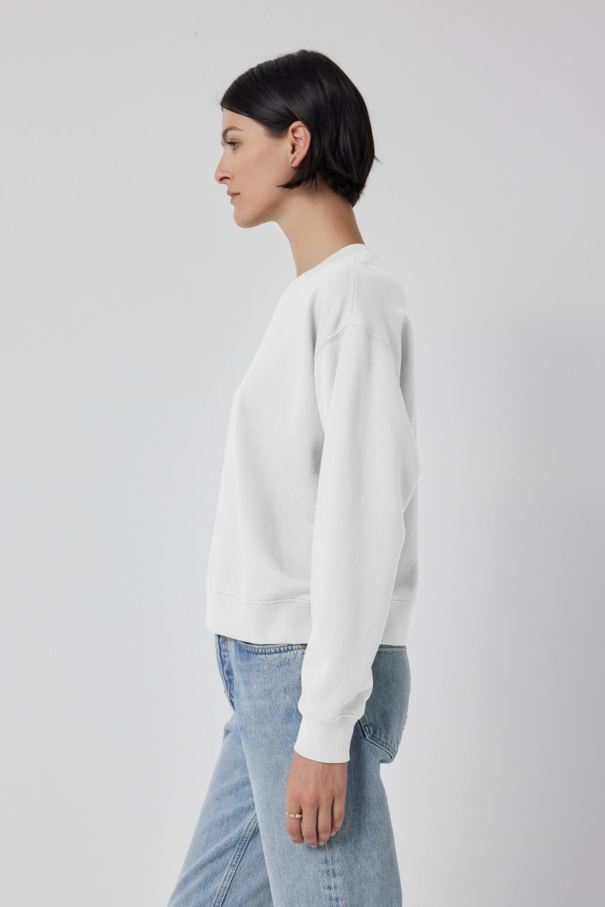   The model is wearing a YNEZ SWEATSHIRT made of organic cotton by Velvet by Jenny Graham and jeans. 