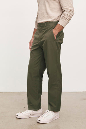 Man standing side-on wearing Velvet by Graham & Spencer's STING POPLIN PANT and white sneakers.