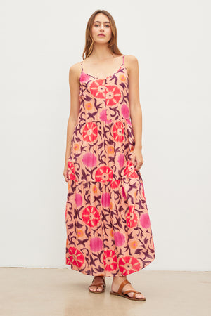 A woman donning an elegant Velvet by Graham & Spencer KATE PRINTED SILK COTTON VOILE TANK DRESS with adjustable straps.