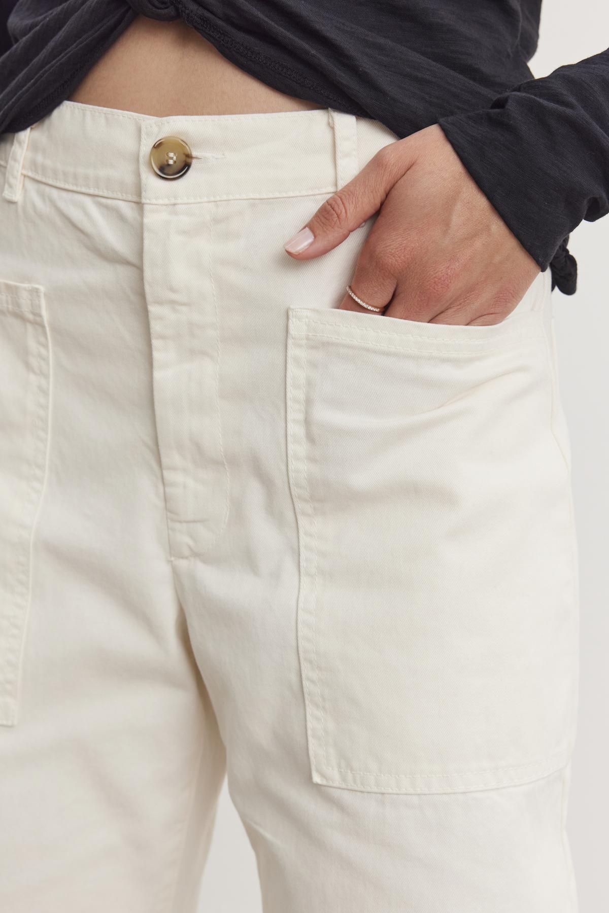   A person casually rests their hand in the pocket of BRYLIE SANDED TWILL UTILITY PANT by Velvet by Graham & Spencer. 