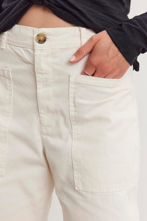 A person casually rests their hand in the pocket of BRYLIE SANDED TWILL UTILITY PANT by Velvet by Graham & Spencer.