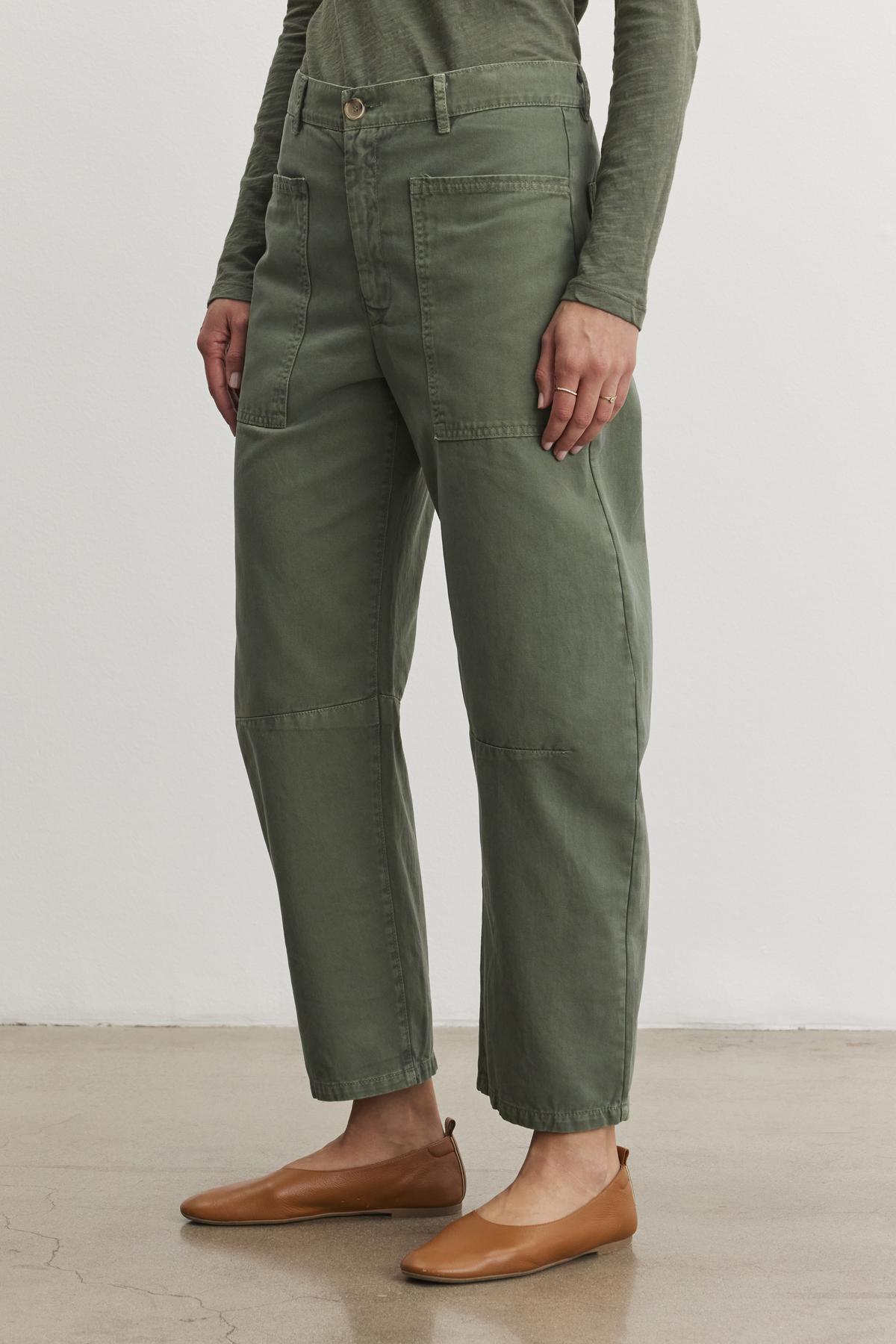 Someone wearing BRYLIE SANDED TWILL UTILITY PANT by Velvet by Graham & Spencer, with brown flats, stands against a plain background.-38512044343489