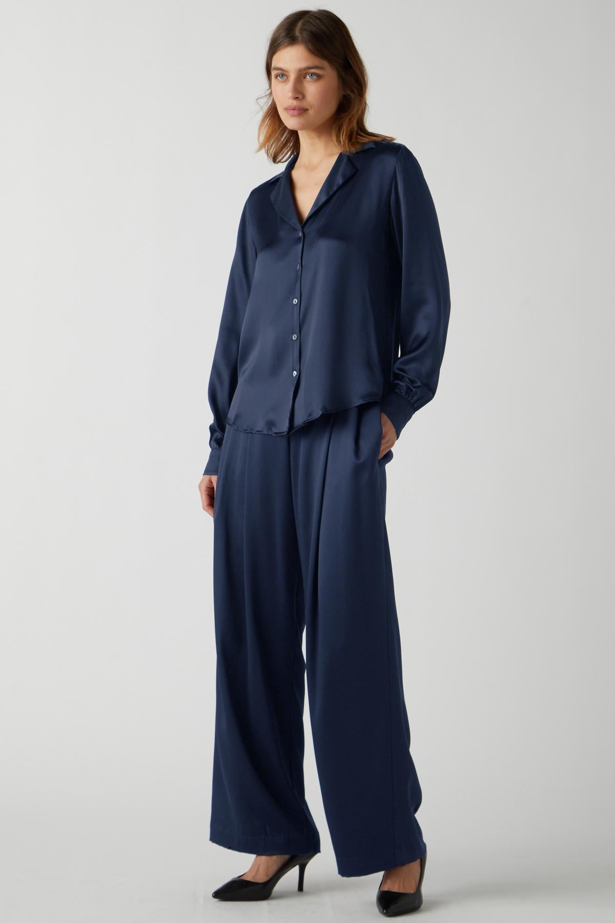   The model is wearing a Velvet by Jenny Graham SOHO TOP and wide leg pants. 