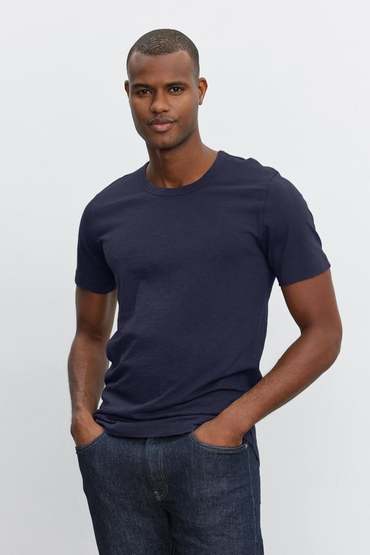   Man in a navy blue Velvet by Graham & Spencer AMARO TEE posing against a white background. 