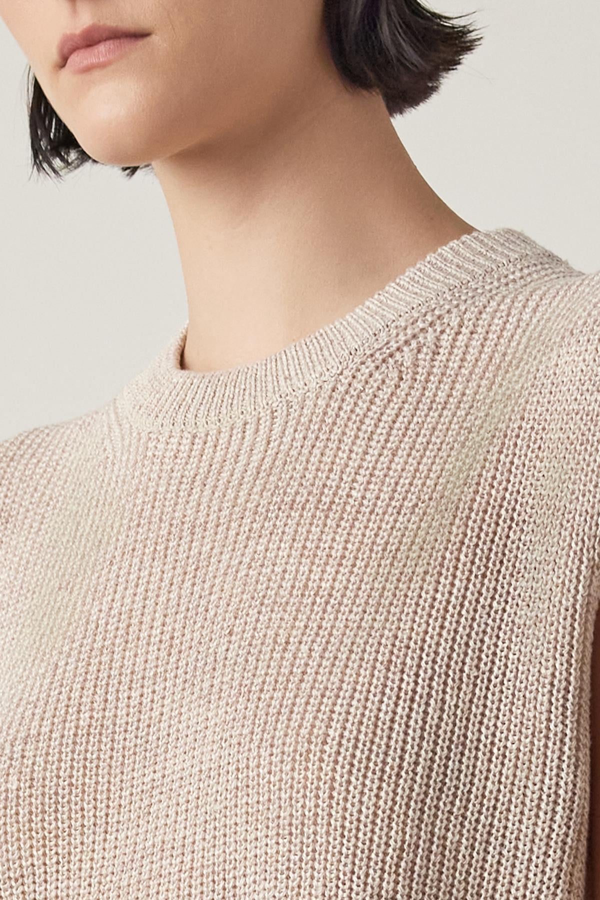   Woman wearing a GARDENA LINEN SWEATER VEST by Velvet by Jenny Graham with a round neckline, cropped at her shoulders, focusing on the texture of the fabric. 