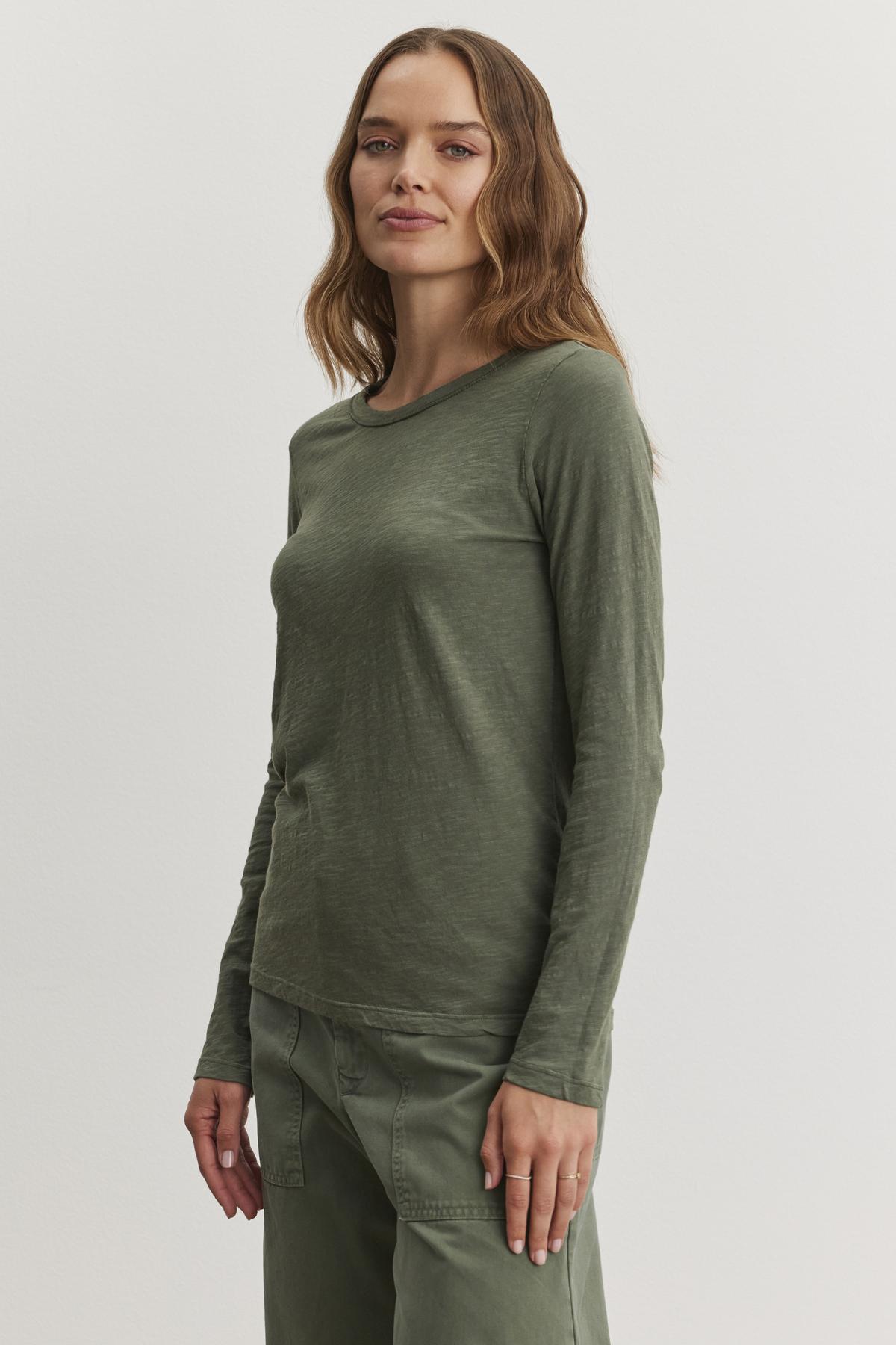   A person with long hair is wearing the LIZZIE TEE from Velvet by Graham & Spencer along with matching pants, standing against a plain background. 