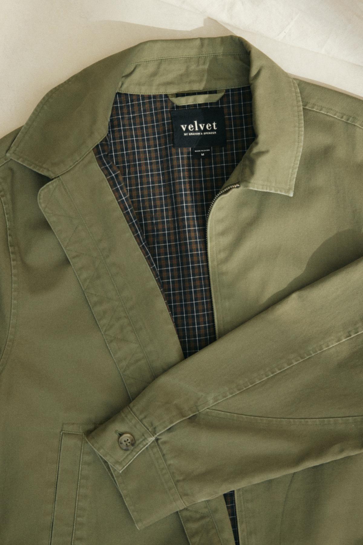   Olive green COLLINS JACKET by Velvet by Graham & Spencer, featuring a plaid inner lining and branded with 