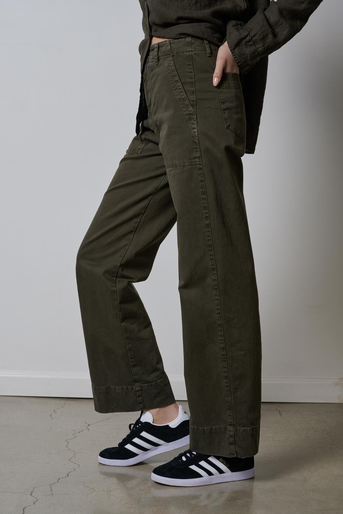   A woman wearing a pair of Velvet by Jenny Graham VENTURA PANTS and sneakers. 