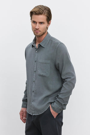 A man with light brown hair and a beard wearing the WOLF BUTTON-UP SHIRT by Velvet by Graham & Spencer stands against a white background.