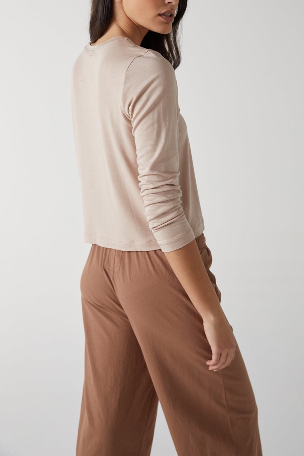   The model is wearing Velvet by Jenny Graham tan wide leg pants and a beige sweater. 