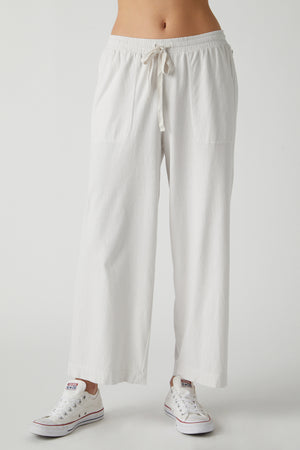 A woman wearing a white Velvet by Jenny Graham PISMO PANT.